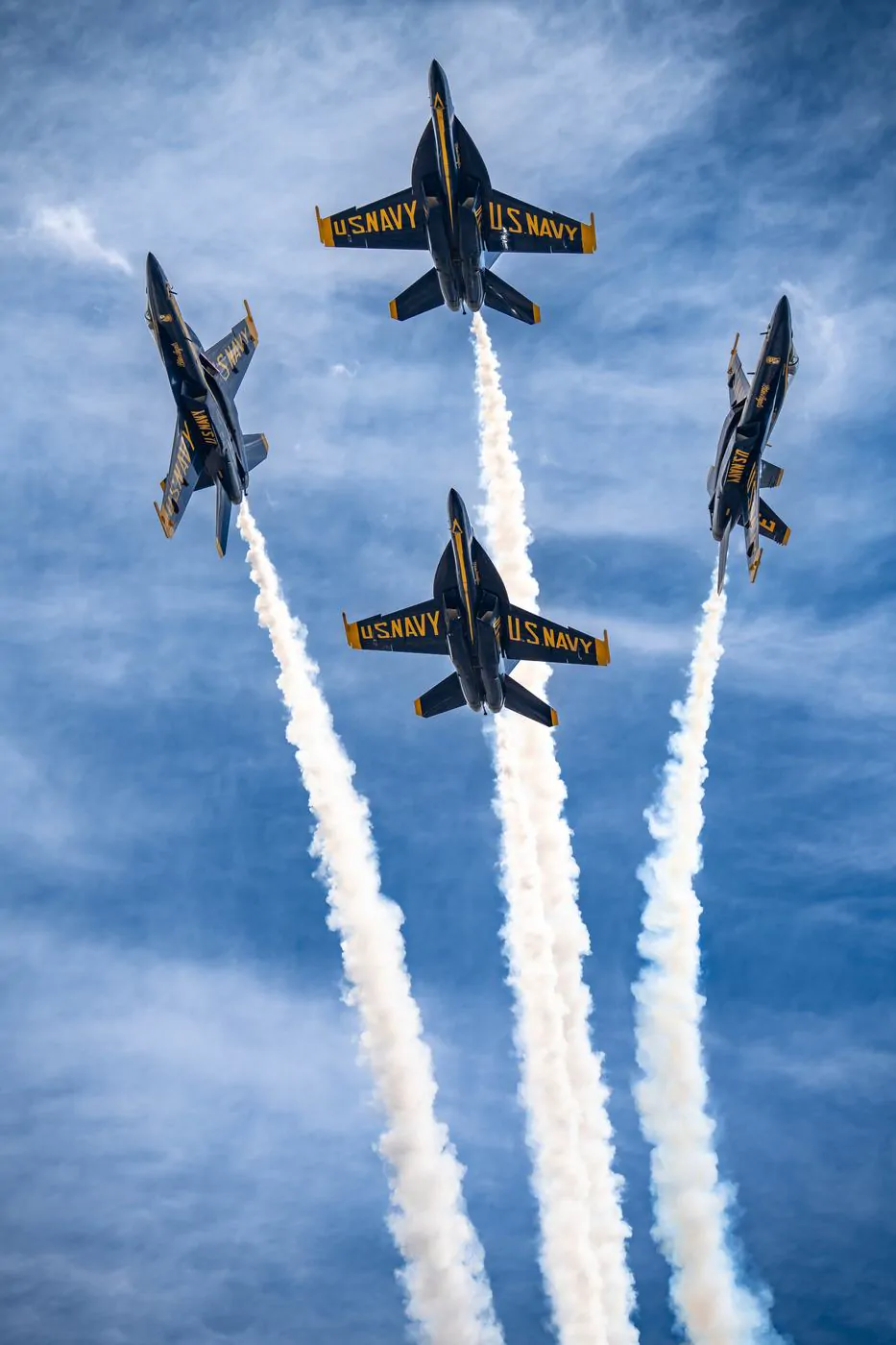 Blue Angels jets in diamond formation, vertical climb